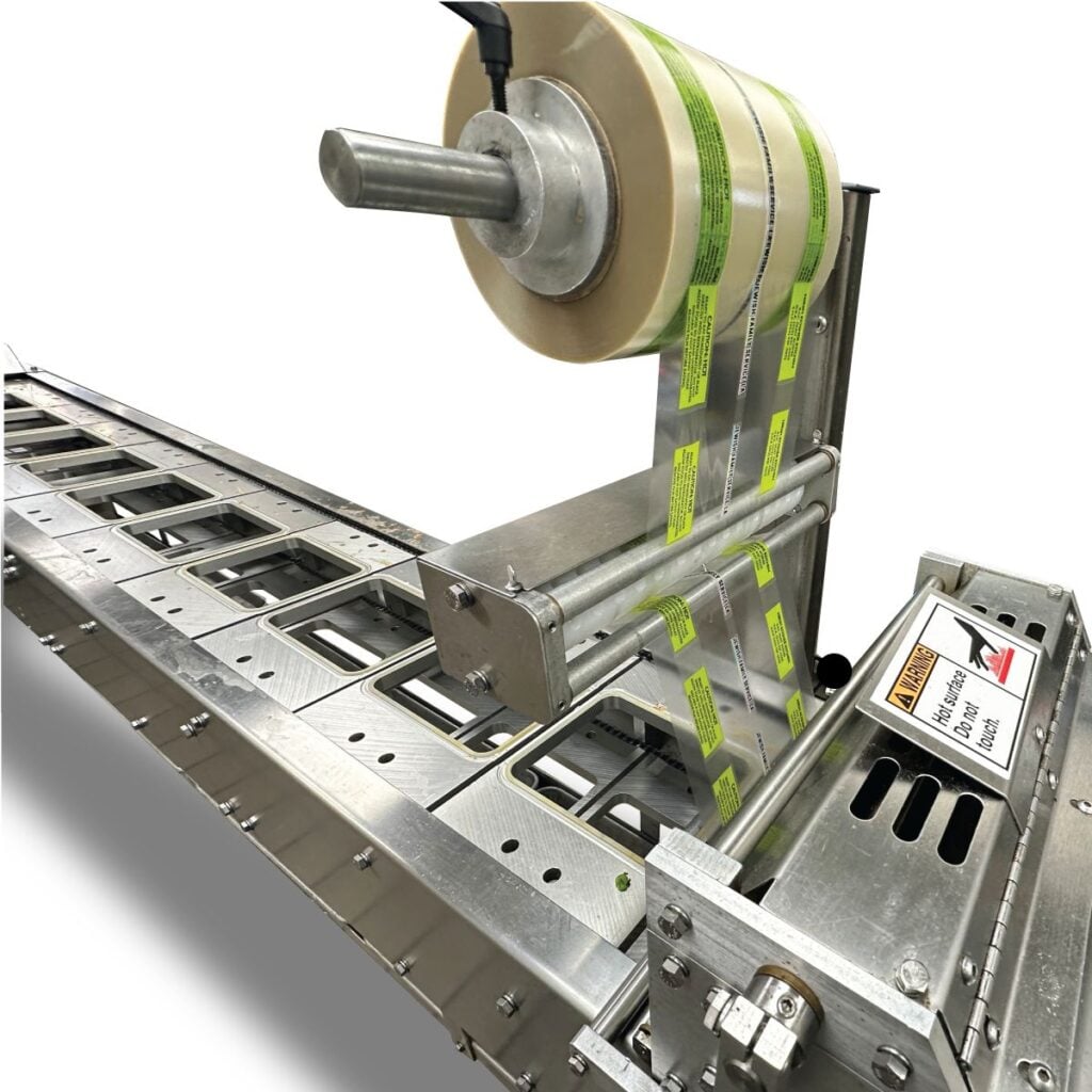 Tray sealer machine with lidding film